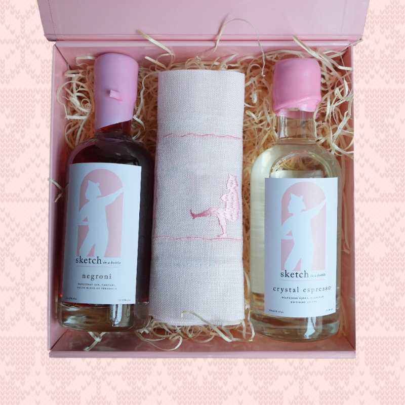 Load image into Gallery viewer, Two bottles with pink caps and a white cloth in a gift box on a pink background