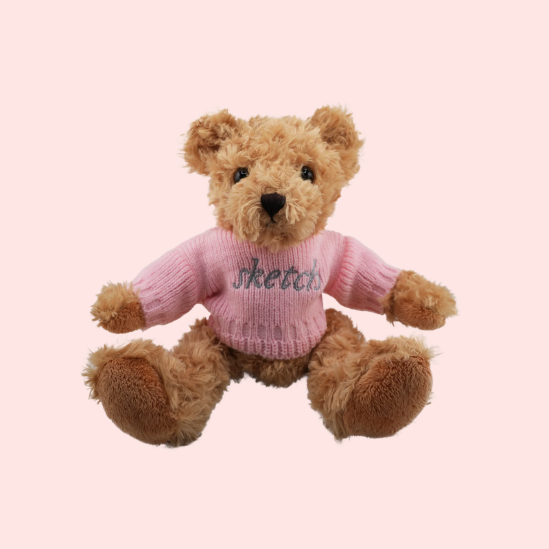Load image into Gallery viewer, Teddy bear wearing a pink sweater with 'Sketch' text on a pink background