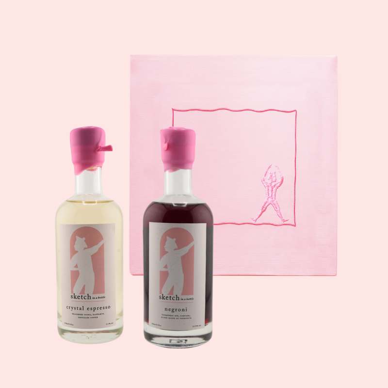 Load image into Gallery viewer, Two bottles of sketch co. alcohol on a pink background with a logo.