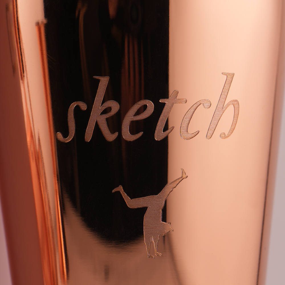 Load image into Gallery viewer, Rose gold product with 'sketch' branding and a small logo on a reflective surface.